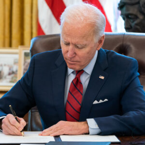 President Joe Biden signs two executive orders on healthcare Thursday, Jan. 28, 2021, in the Oval Office of the White House. (Official White House Photo by Adam Schultz)