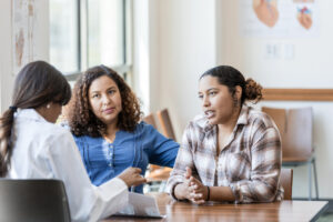 Young adult female asks the doctor questions about her test results stock photo